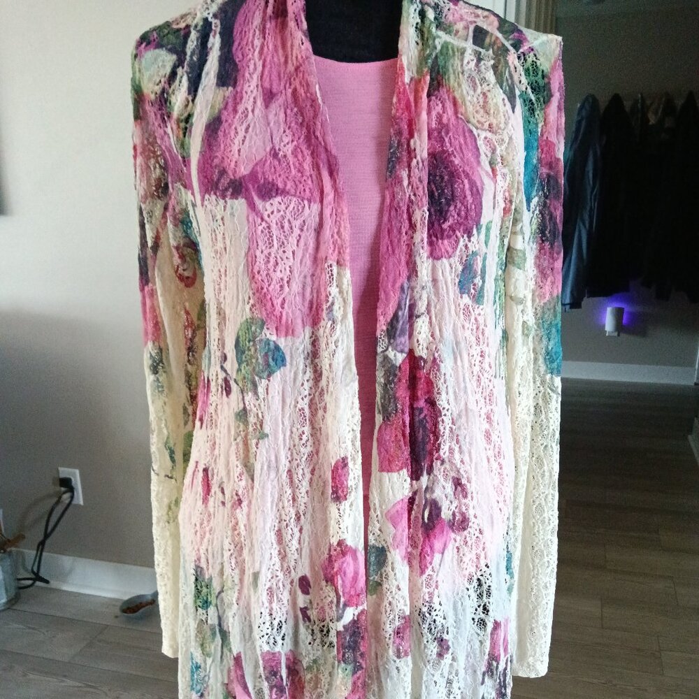 A floral lace  jacket with magenta pink roses on a cream background